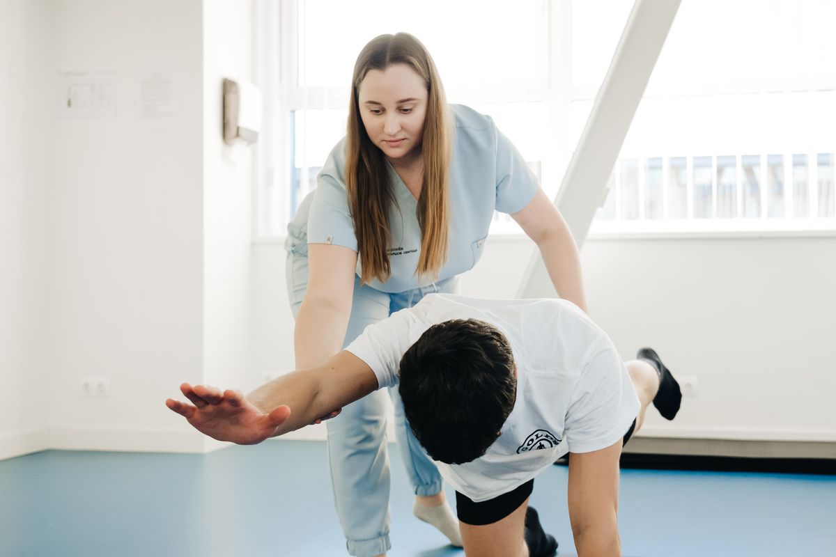 A therapist assisting a patient with an exercise