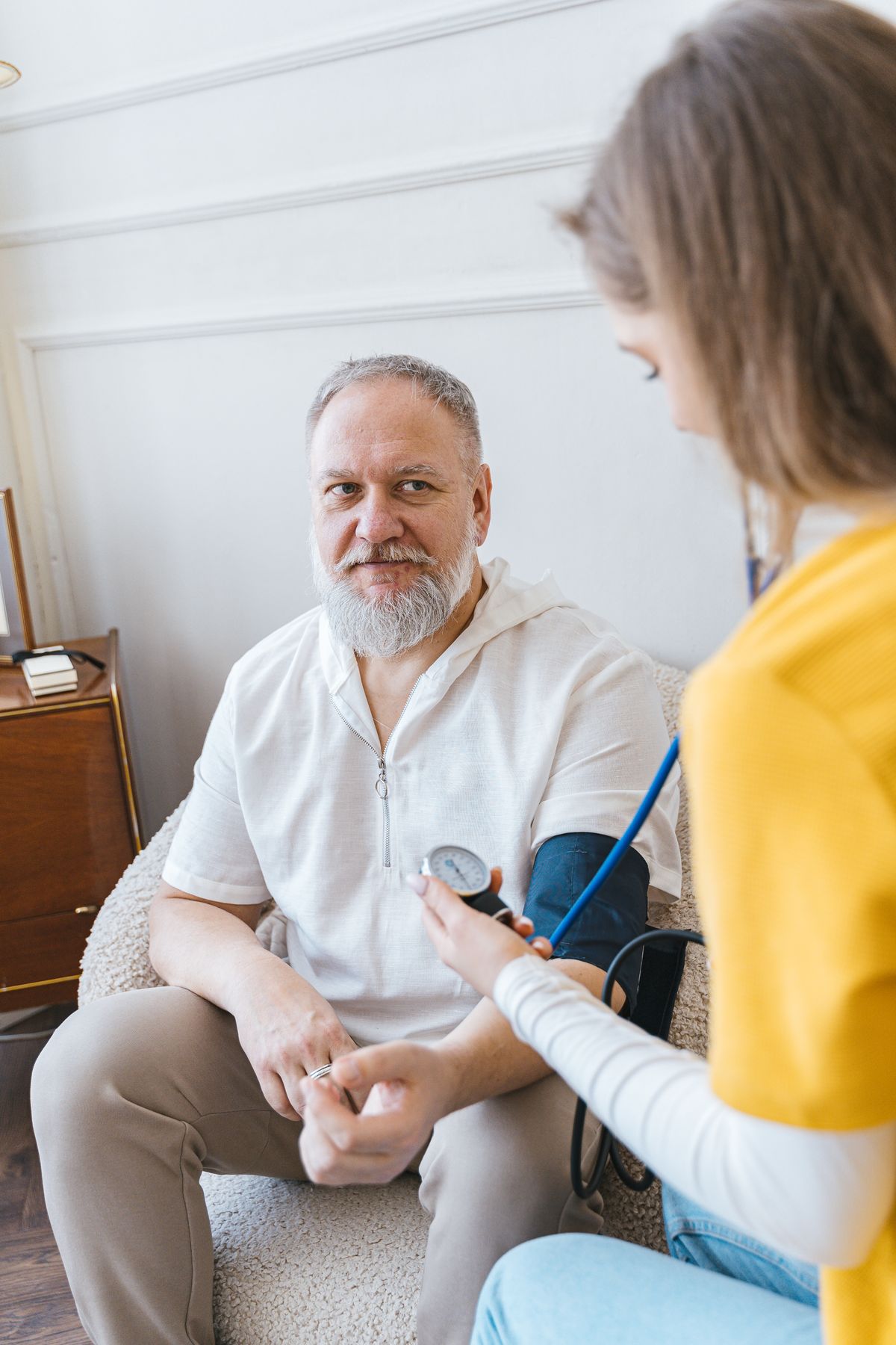 A nurse attending to a patient at home